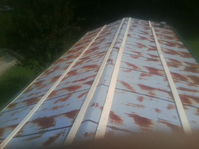 Rusted metal roof panels with new wood purlins before replacement — Storm Damage Roof Repair in Clifton by Roofing Brothers
